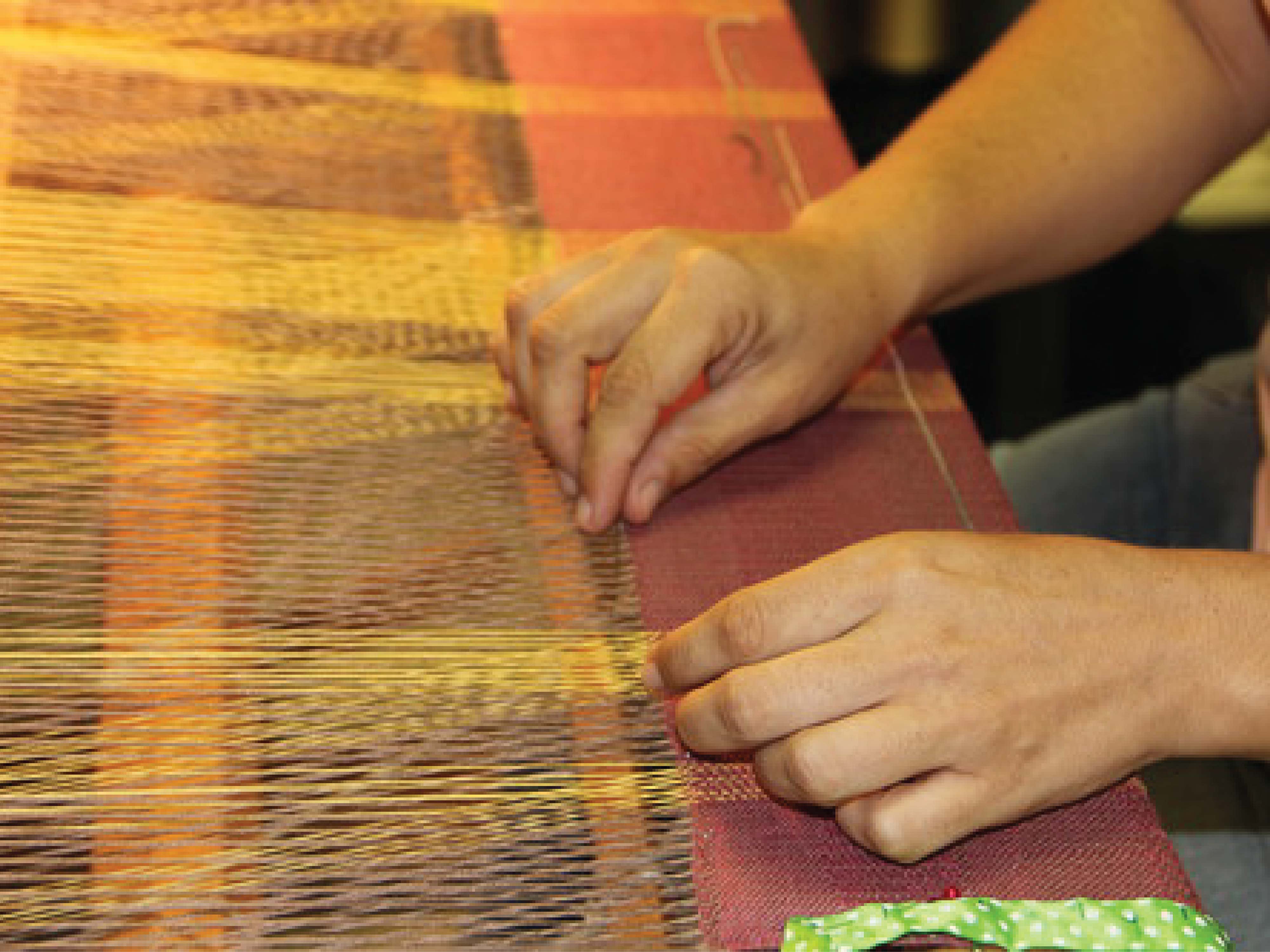 person working on loom