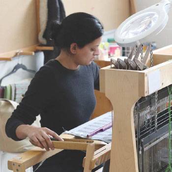 Female student at fiber loom