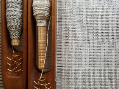 Detail photograph of loom weaving equipment and supplies.