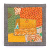 quilt square with different fabric patterns and gray border