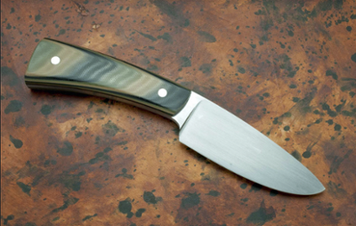 Example of a camp knife that will be made during the course, having a polished wooden handle and sharp well formed blade.