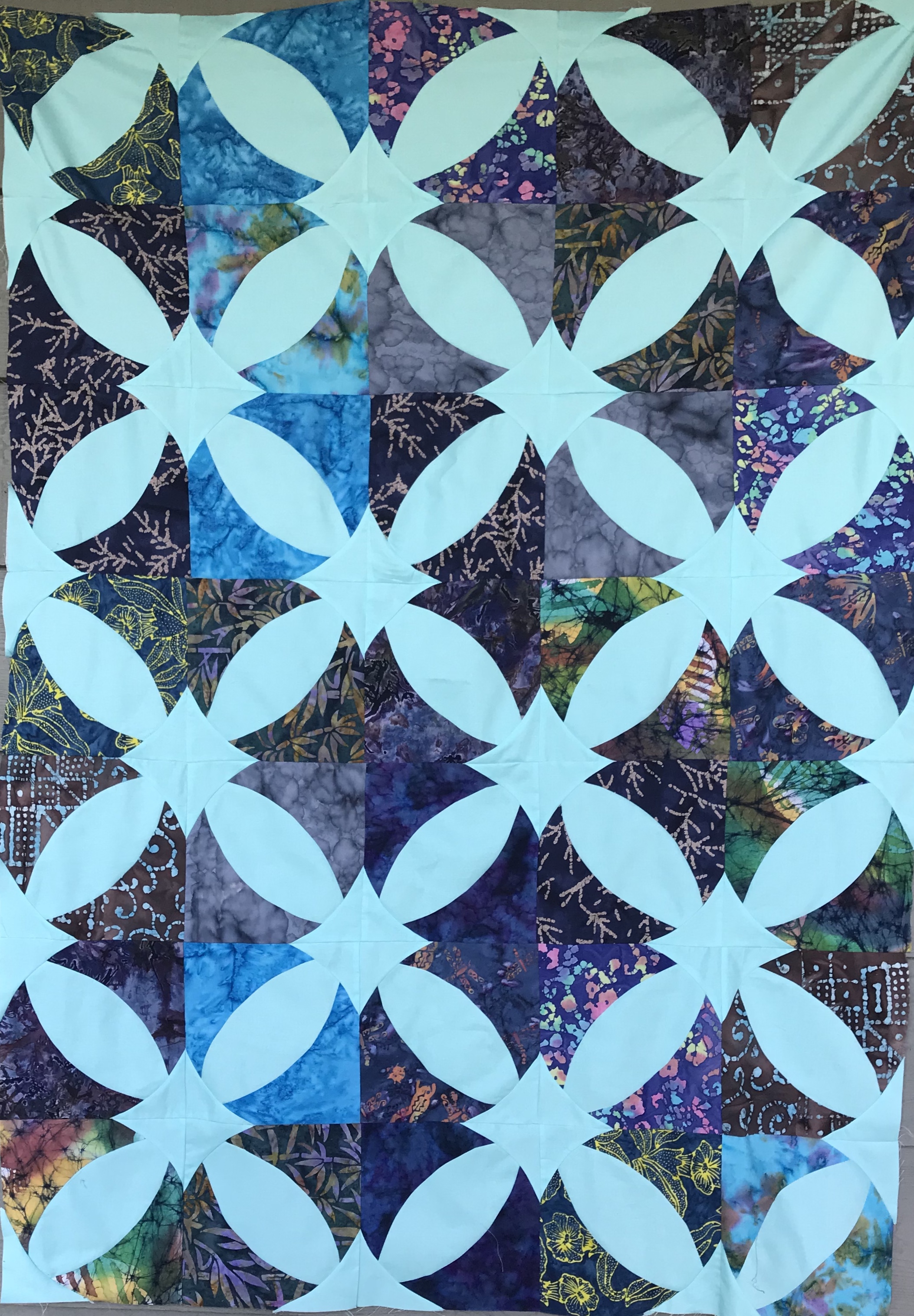 A patterned blue and dark blue quilt