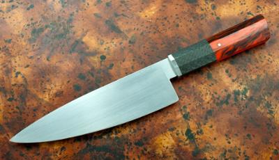 Chef Knife with red handle on brown granite background