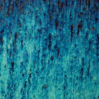 Close-up abstract texture with layered streaks of turquoise and deep blue paint, with darker speckles and vertical brush-like drips throughout.