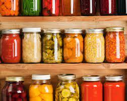 A colored photograph of jars filled with preserved fruit and vegetables.