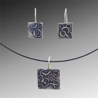 Pairs of blueish-gray earrings show what could be created in the class.