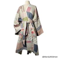 scissors and garment drawing with other sewing items on a desk