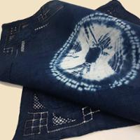 A close up of hand painted fabric using plant based dyes.