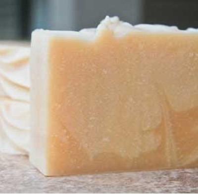 A closeup of a homemade bar of cream coloredsoap. 