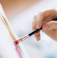 painting pink on canvas with paintbrush