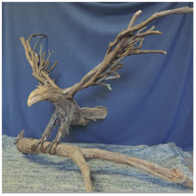 A wood sculpture made from branches and twigs to make the 3-d shape of an eagle.