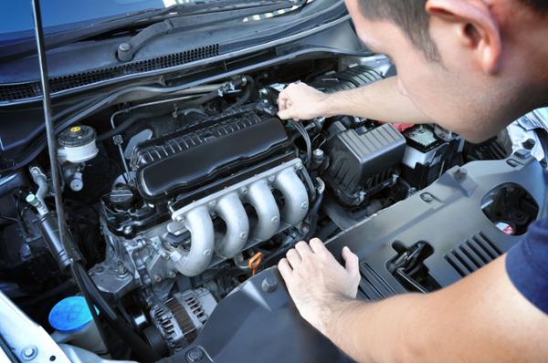 Man looking at engine close up