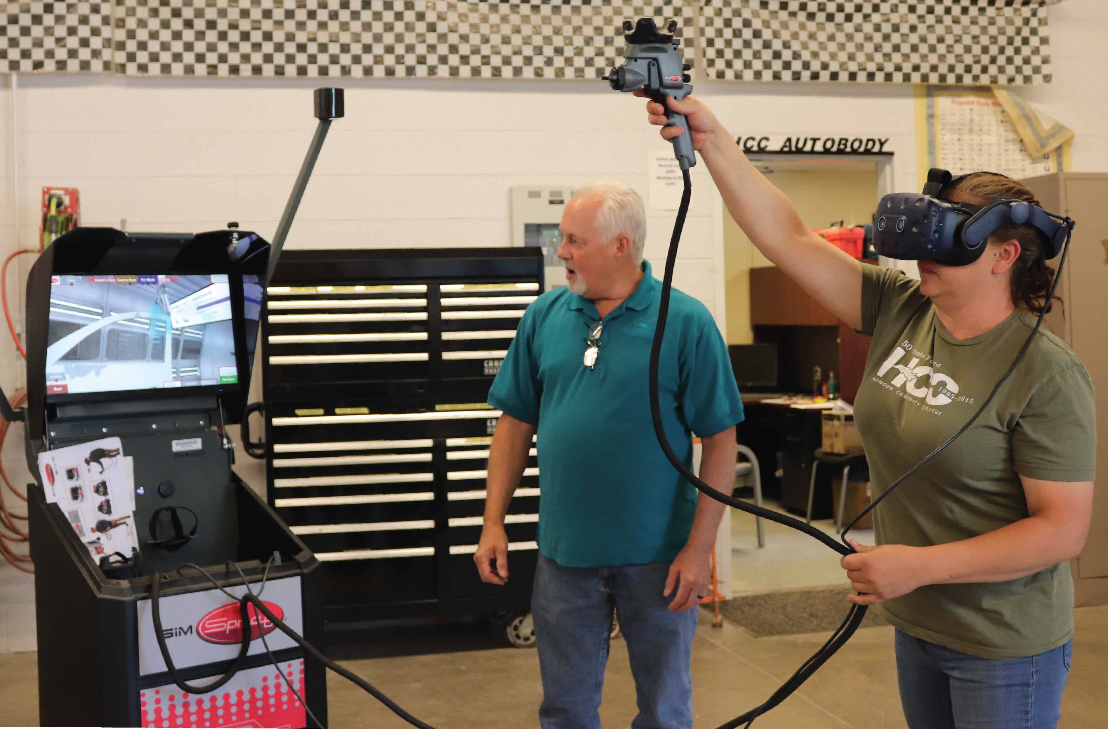 HCC’s Collision & Repair program received a Sim Spray, a machine that allows users to paint car parts virtually. Pictured left to right are instructors Mark Hicks and Heather Patterson demonstrating. 