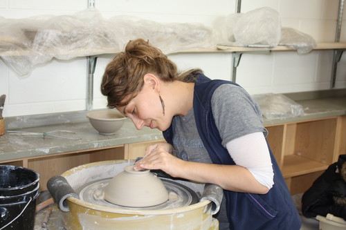 girl making clay pot