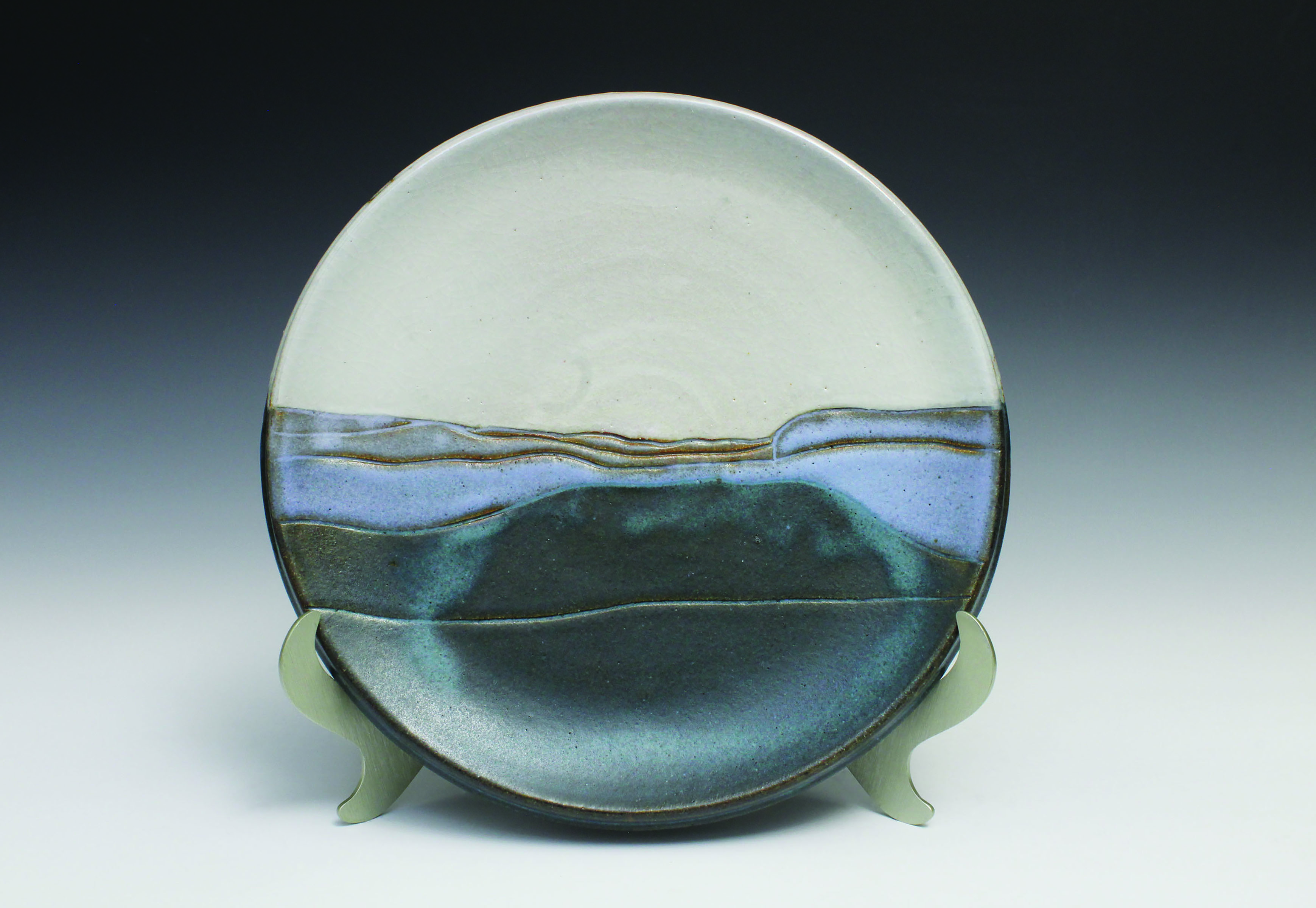 clay plate with blue on bottom, gray on top