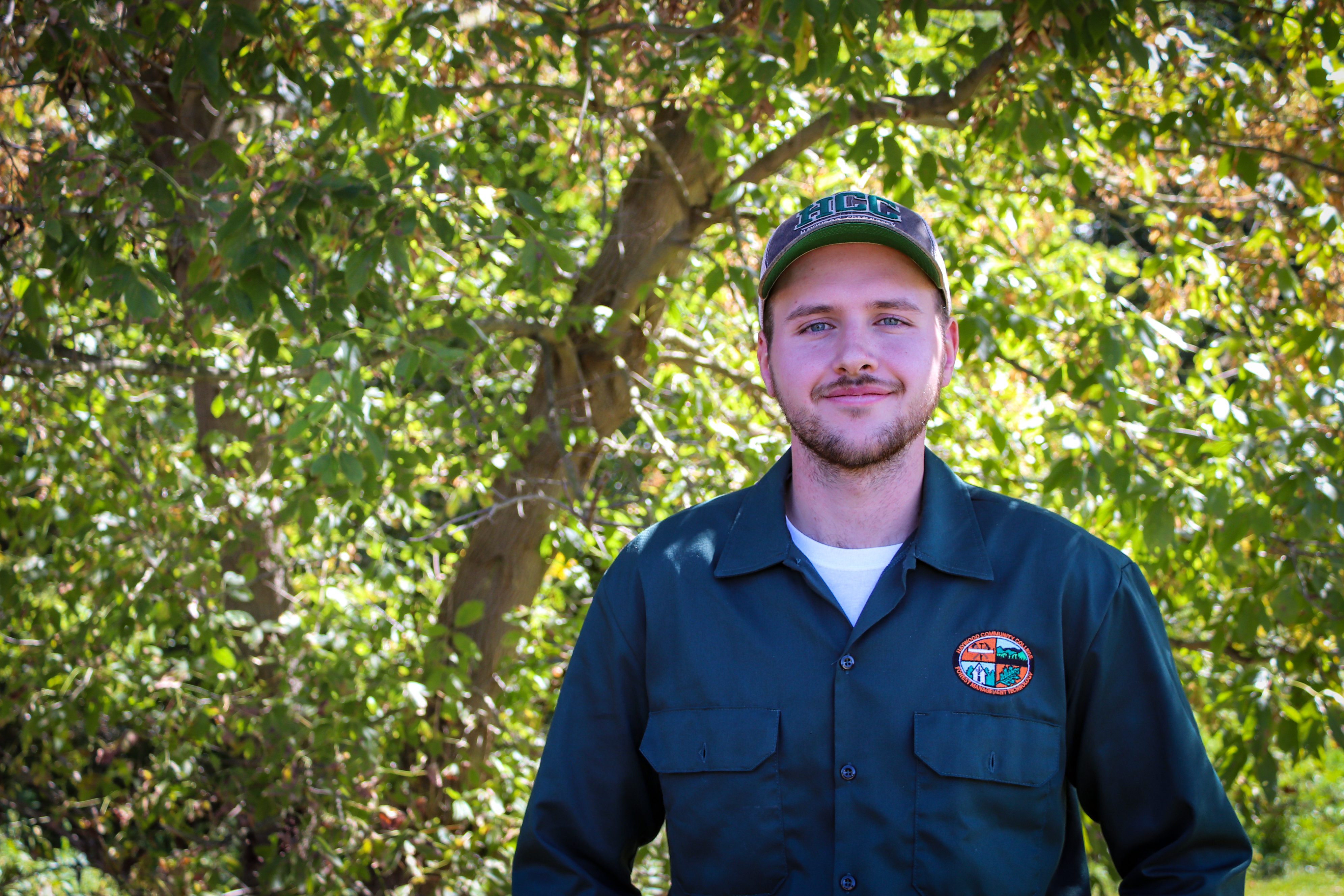 Ezra Messer HCC student in HCC hat in woods