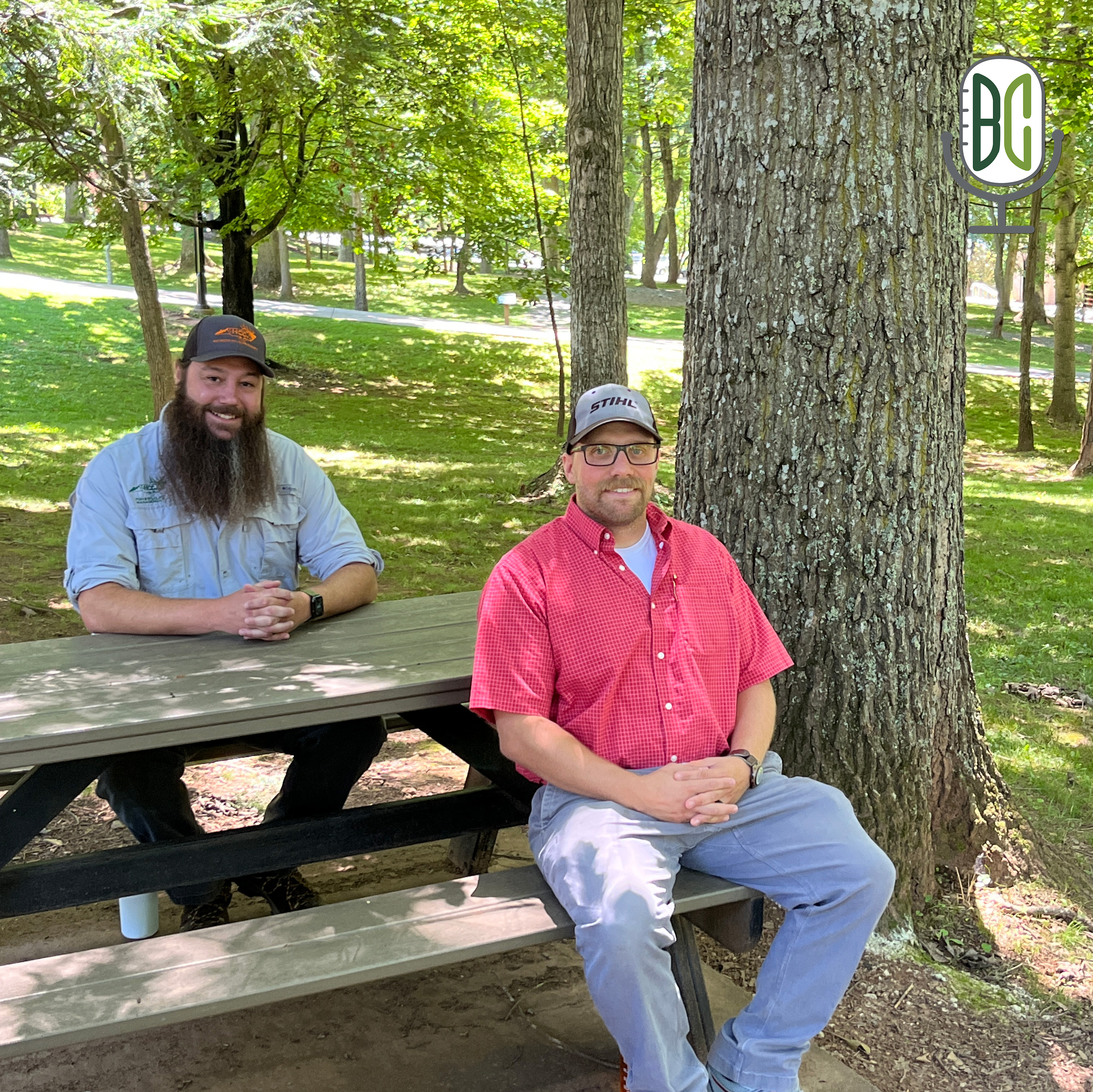 Andrew Isenhower and George Hahn sitting at a bench on campus