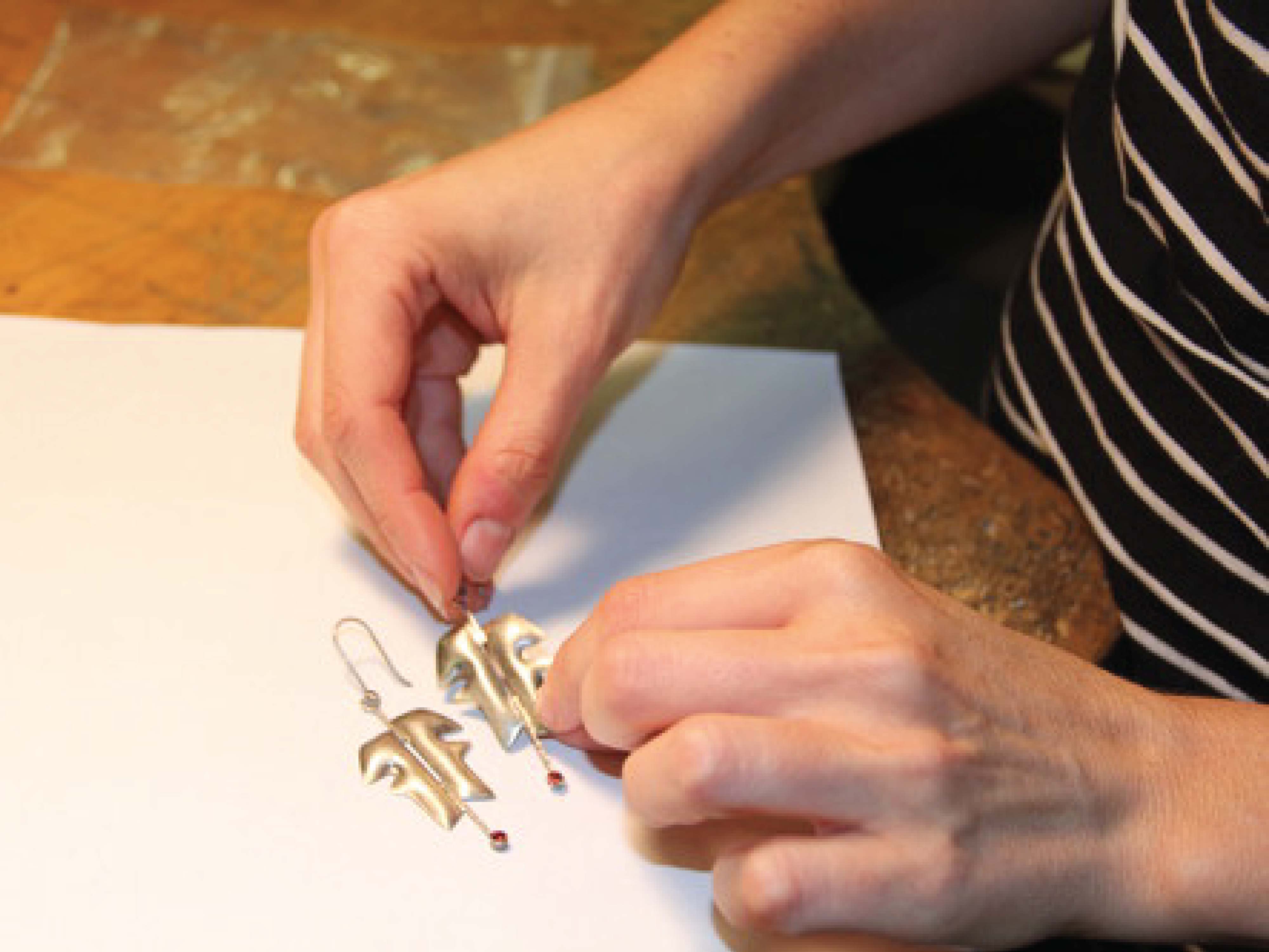 person working on earrings