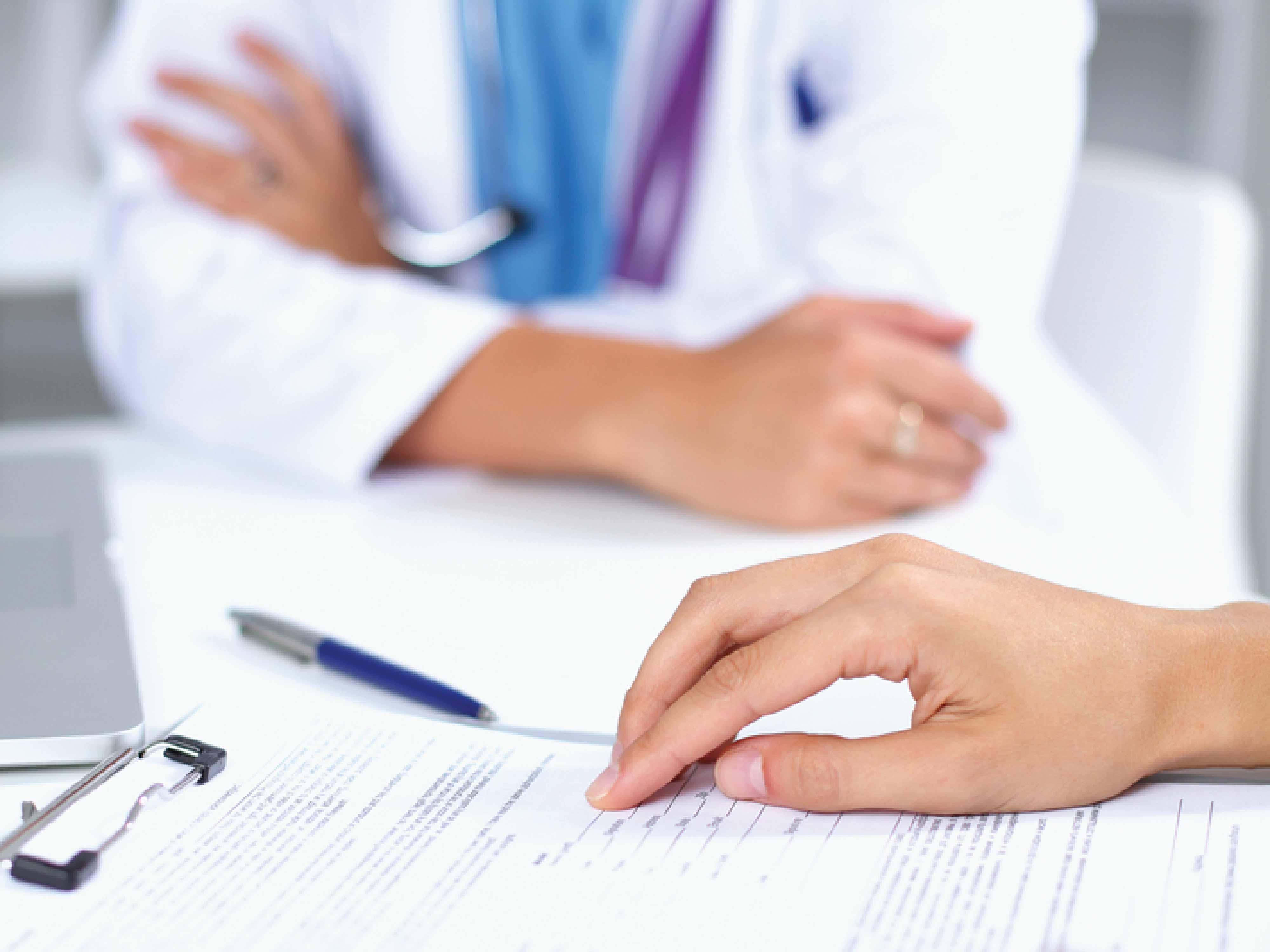 person looking at medical clipboard