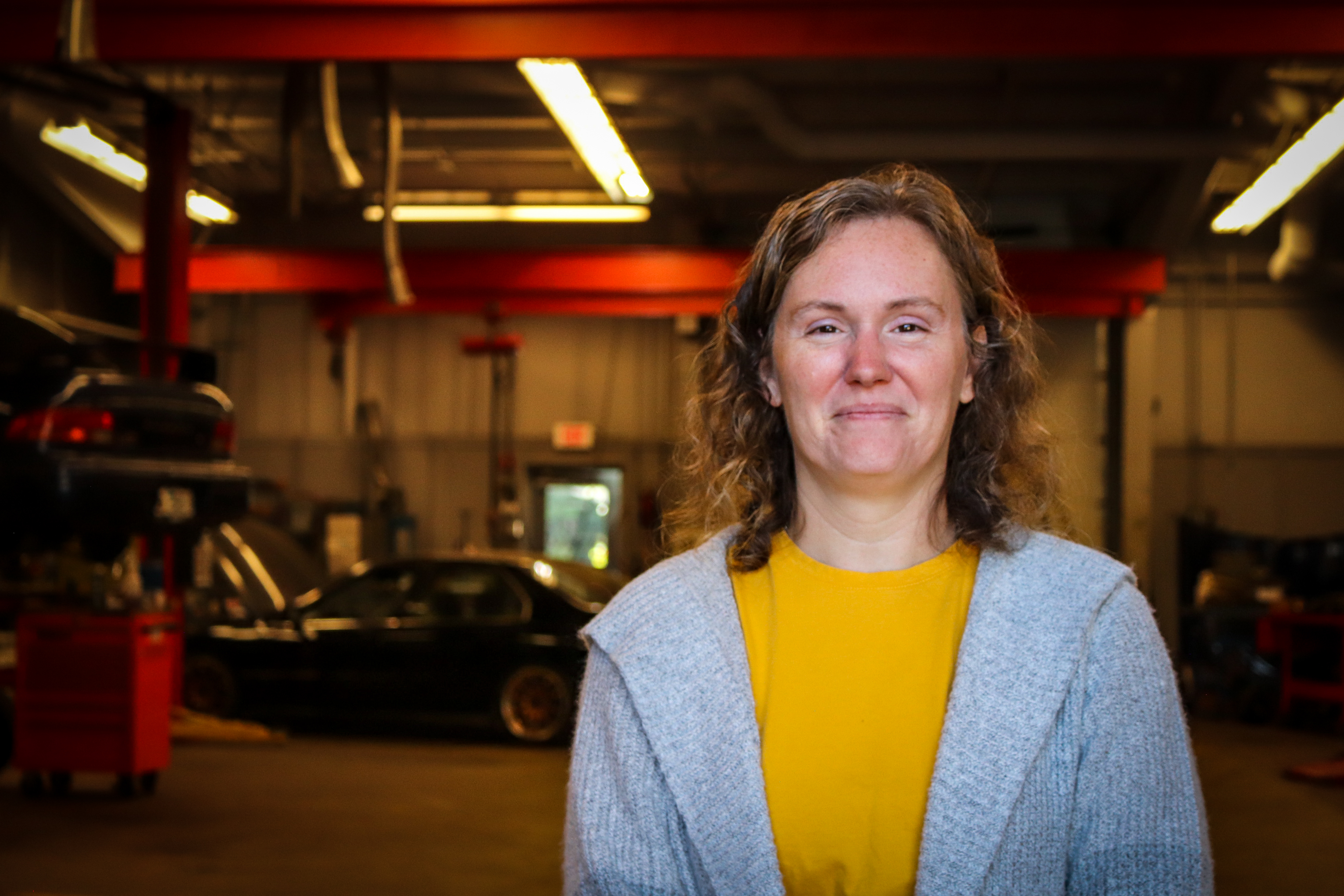 Stephanie in gray sweater in automotive department